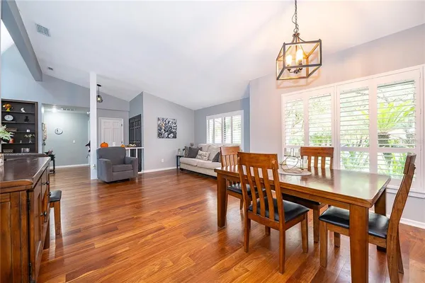 a view of a dining room with furniture window and wooden floor