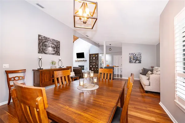 a living room with dining room and wooden floor