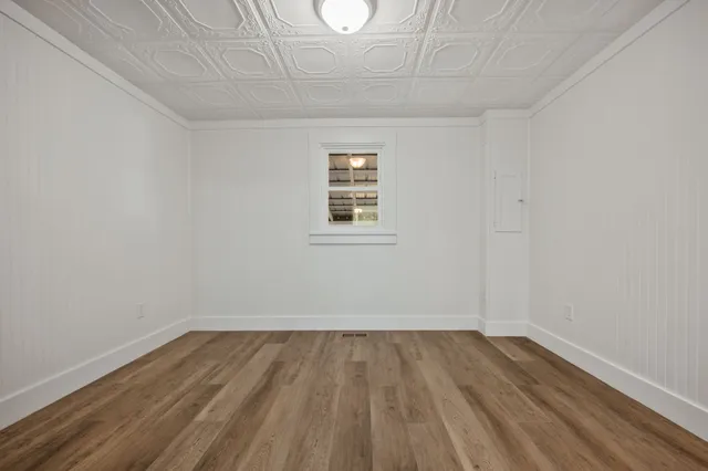 a bathroom with a granite countertop sink a toilet and shower