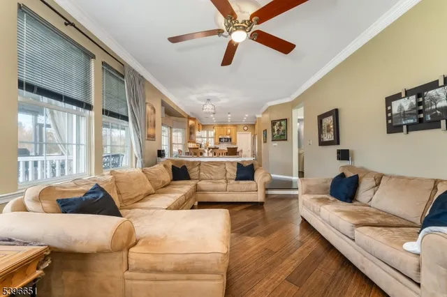 a living room with furniture and a pool table