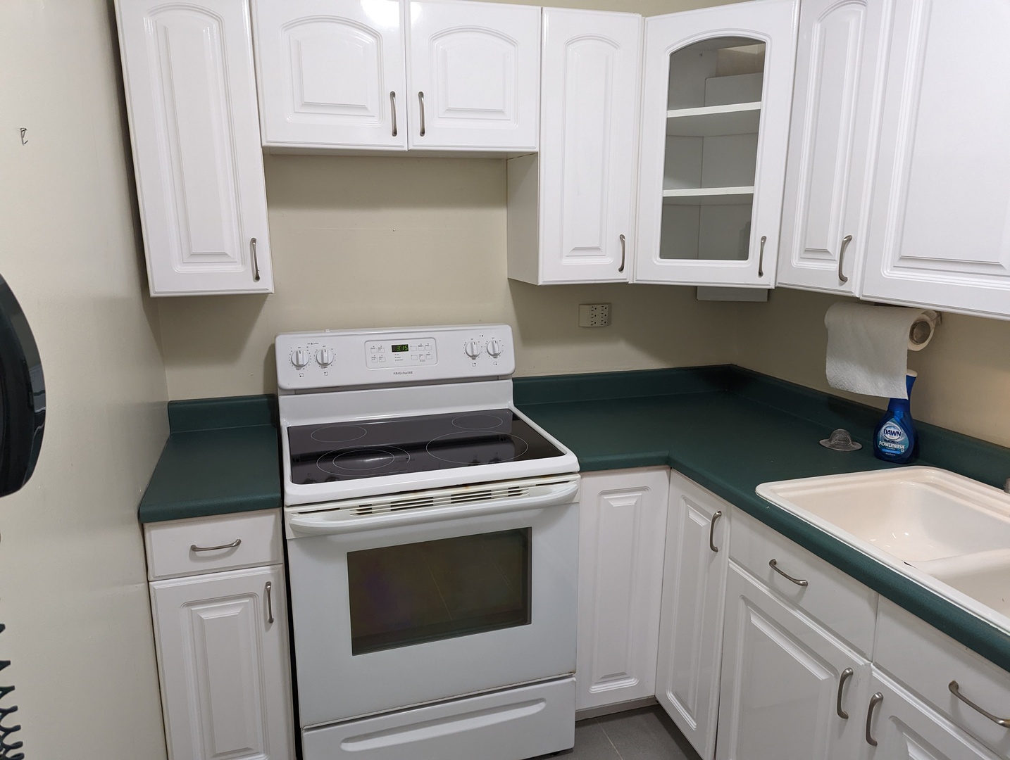 720 West Gordon Terrace, Unit 7J Chicago, IL 60613 - Photo 4 of 14 a kitchen with granite countertop white cabinets and white appliances