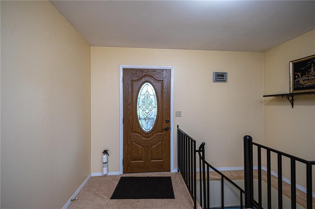 341 Pittsburgh Grade Road Hookstown, PA 15050 - Photo 4 of 23 Entry from Front Porch shows Iron Railing for Spiral Staircase to lower level.