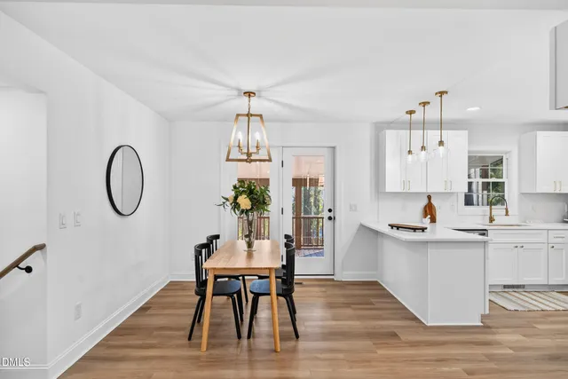 a kitchen with a table and chairs in it