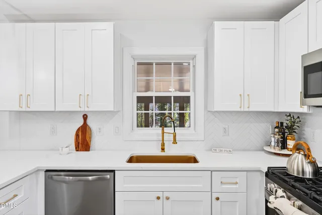 a kitchen with white cabinets and white appliances