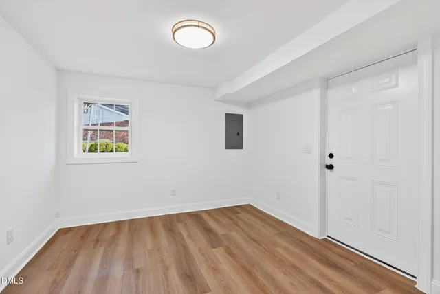 a view of a room with wooden floor