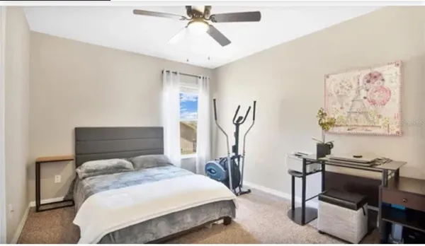 a bedroom with a bed and a desk