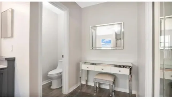 a bathroom with a toilet sink and mirror