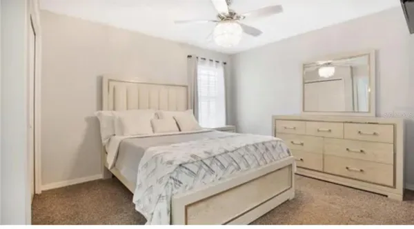 a bedroom with a large bed and a mirror