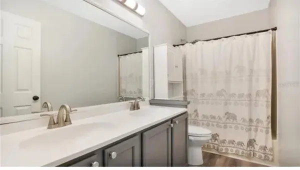 a bathroom with a double vanity sink and a mirror