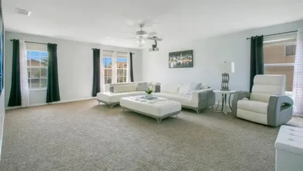 a living room with furniture and a large window
