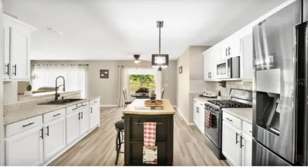 a kitchen with stainless steel appliances a stove sink and cabinets