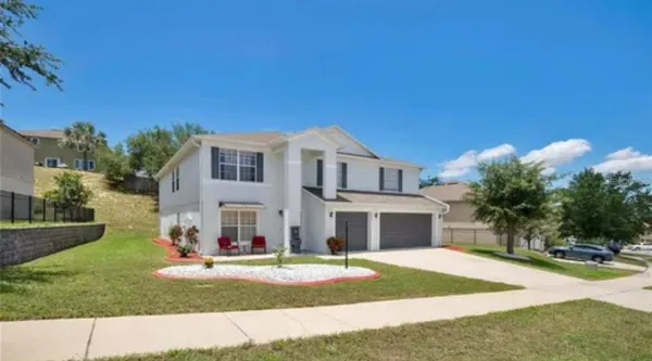 a front view of a house with a yard and garage