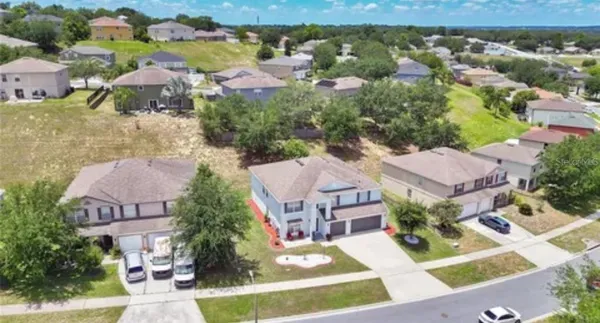 an aerial view of multiple houses with yard