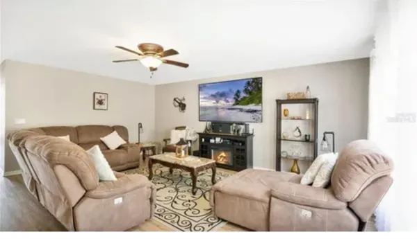 a living room with furniture a couch and a chandelier