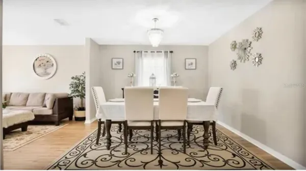 a view of a dining room with furniture and a chandelier