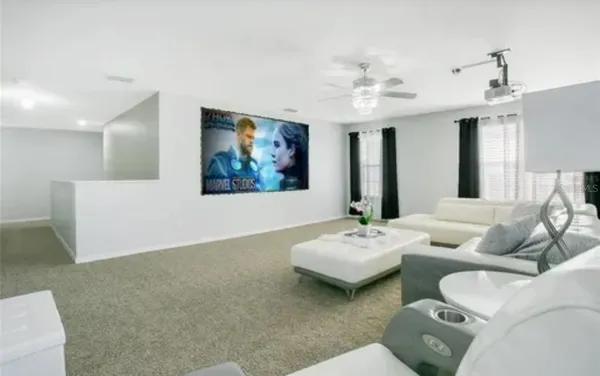a living room with furniture and a chandelier