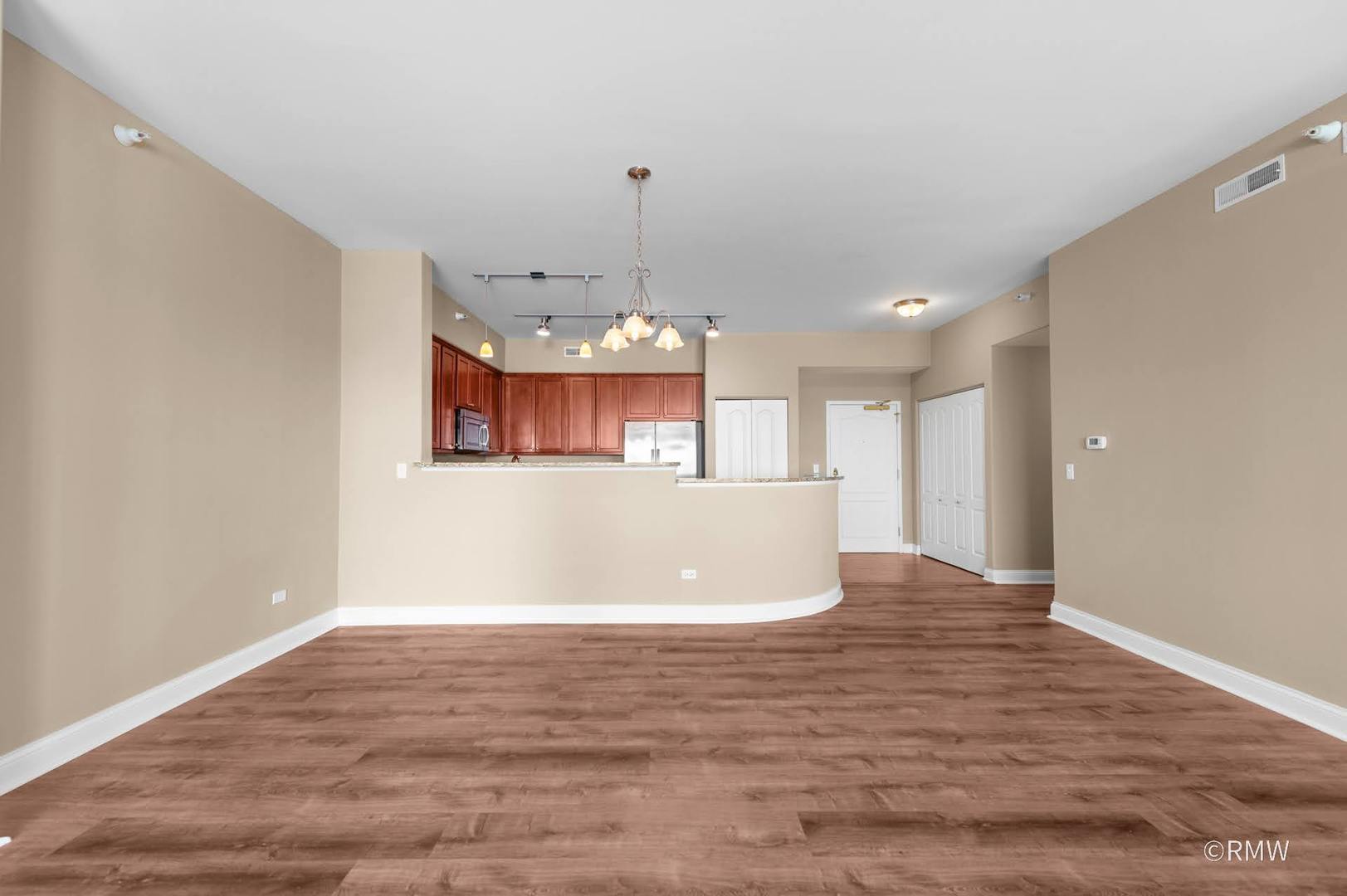 2 Itasca Place, Unit 521 Addison, IL 60143 - Photo 5 of 20 a view of a kitchen with a dishwasher cabinets and wooden floor
