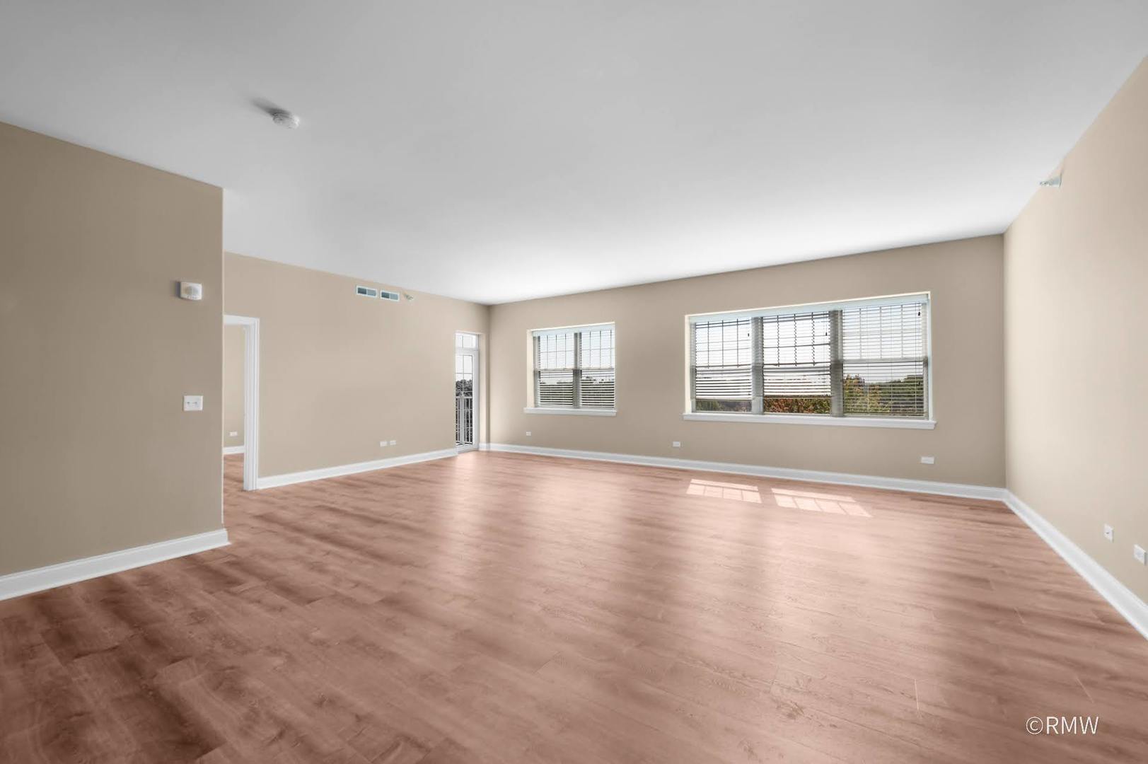 2 Itasca Place, Unit 521 Addison, IL 60143 - Photo 9 of 20 a view of an empty room with window and wooden floor