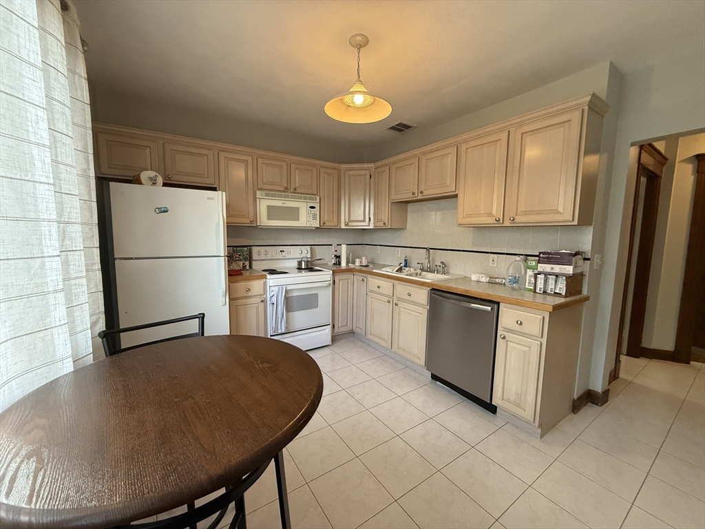 22 Yale Avenue, Unit A Wakefield, MA 01880 - Photo 13 of 23 a kitchen with appliances cabinets and a sink