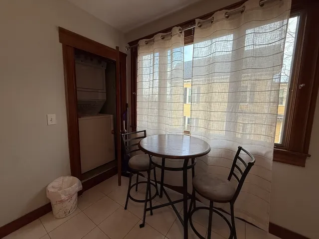 a view of a room with a table and chairs