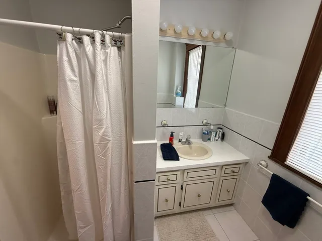 a bathroom with a double vanity sink and mirror