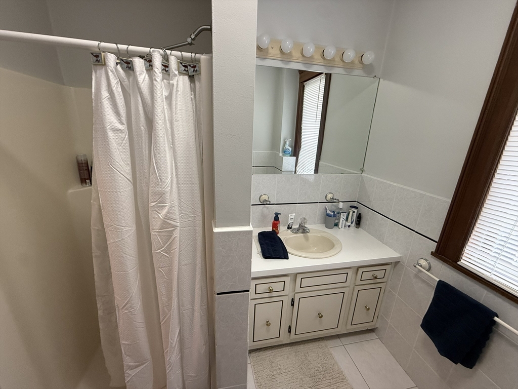 22 Yale Avenue, Unit A Wakefield, MA 01880 - Photo 18 of 23 a bathroom with a double vanity sink and mirror