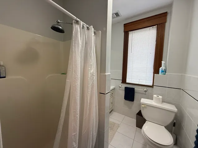 a bathroom with a toilet and shower