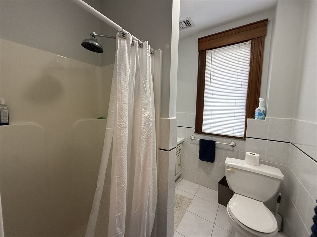 22 Yale Avenue, Unit A Wakefield, MA 01880 - Photo 19 of 23 a bathroom with a toilet and shower