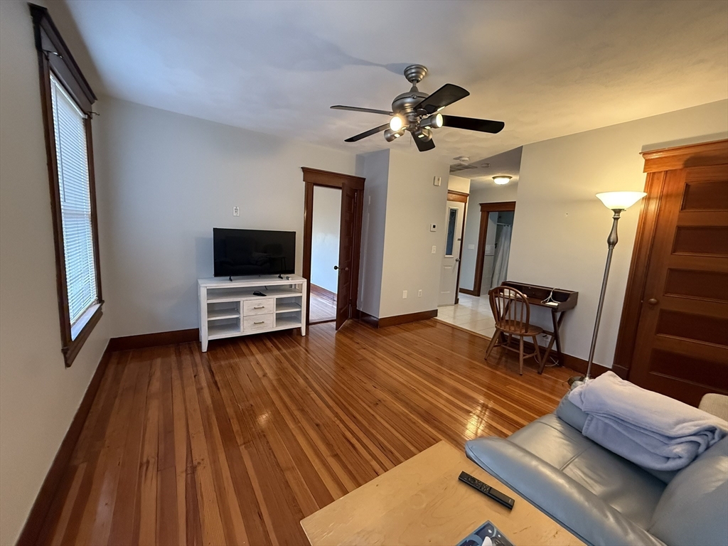 22 Yale Avenue, Unit A Wakefield, MA 01880 - Photo 2 of 23 a living room with furniture flat screen tv and a wooden floor