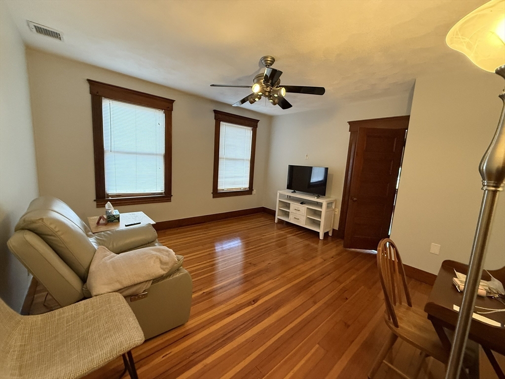 22 Yale Avenue, Unit A Wakefield, MA 01880 - Photo 4 of 23 a living room with furniture and a wooden floor