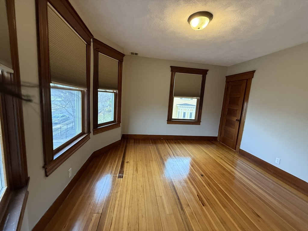 22 Yale Avenue, Unit A Wakefield, MA 01880 - Photo 7 of 23 a view of an empty room with wooden floor and a window