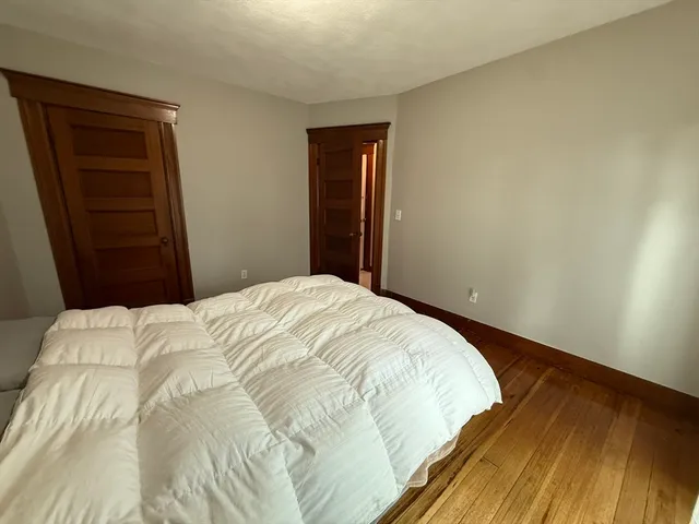 a bedroom with a bed and dresser