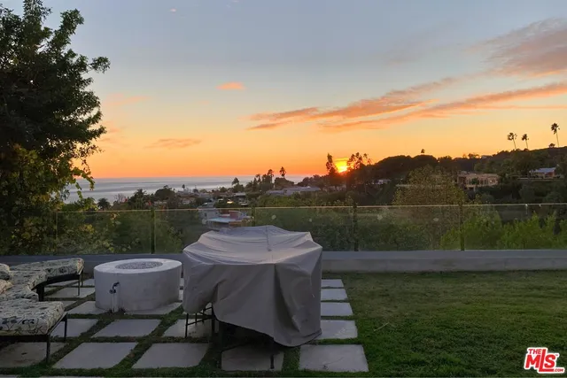 a view of lake with a table and chairs