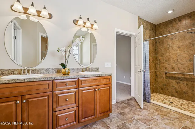 a bathroom with a tub a shower and view