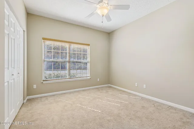 a spacious bedroom with a bed and a large window