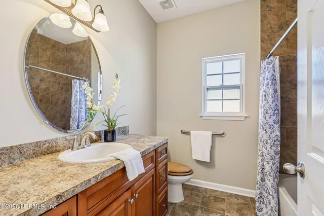 a bathroom with a tub shower and a sink