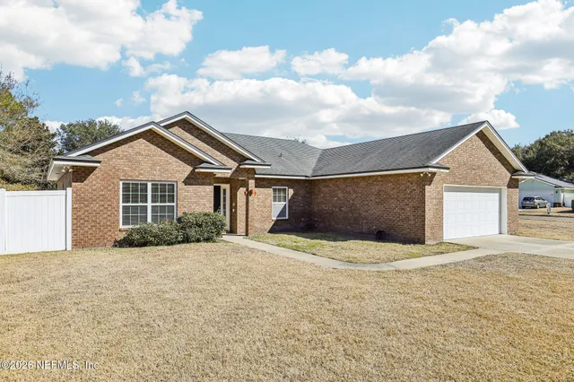 a view of house with yard and entertaining space