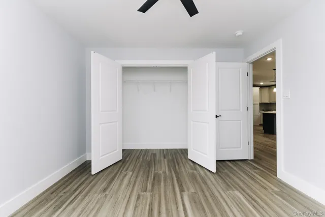 a view of a room with wooden floor and entryway