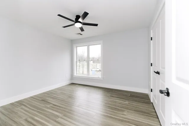 wooden floor in an empty room with a window