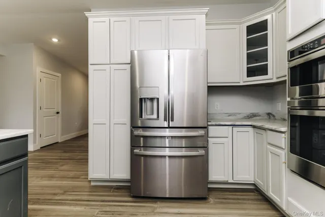 a kitchen with stainless steel appliances a refrigerator and cabinets