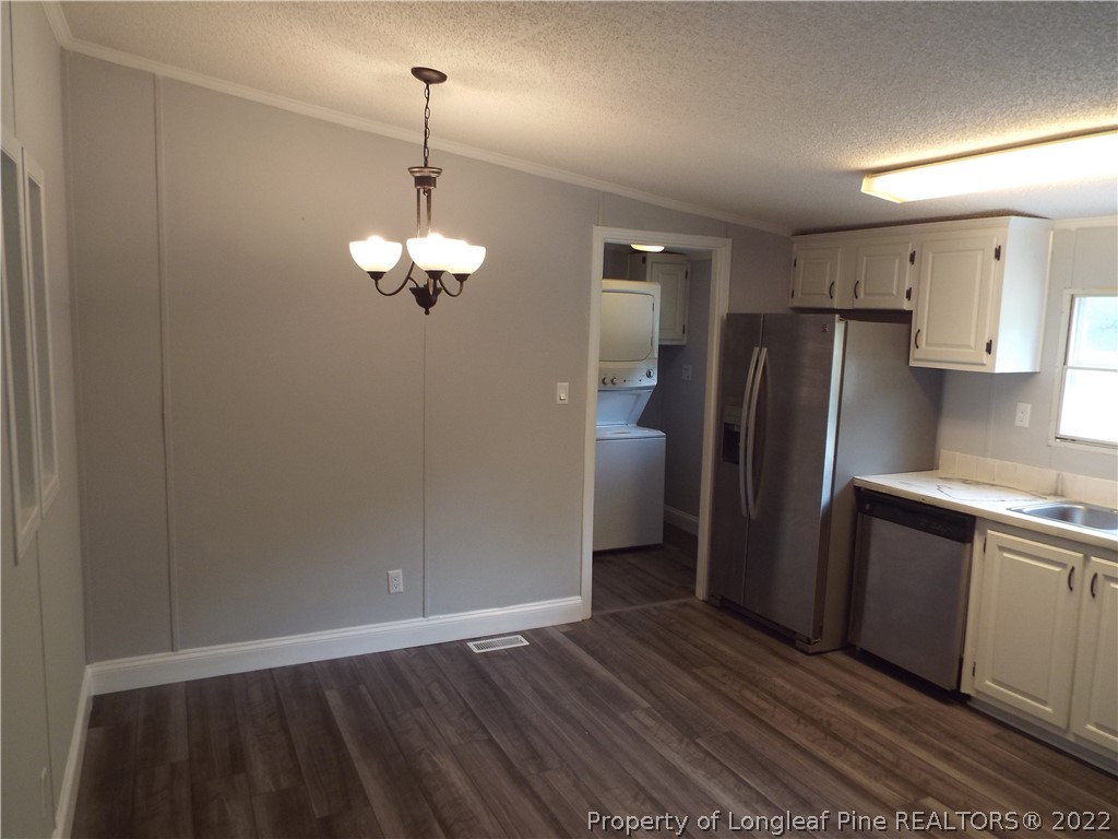 73 Georgia Way Cameron, NC 28326 - Photo 11 of 28 a kitchen with stainless steel appliances granite countertop a refrigerator and a sink