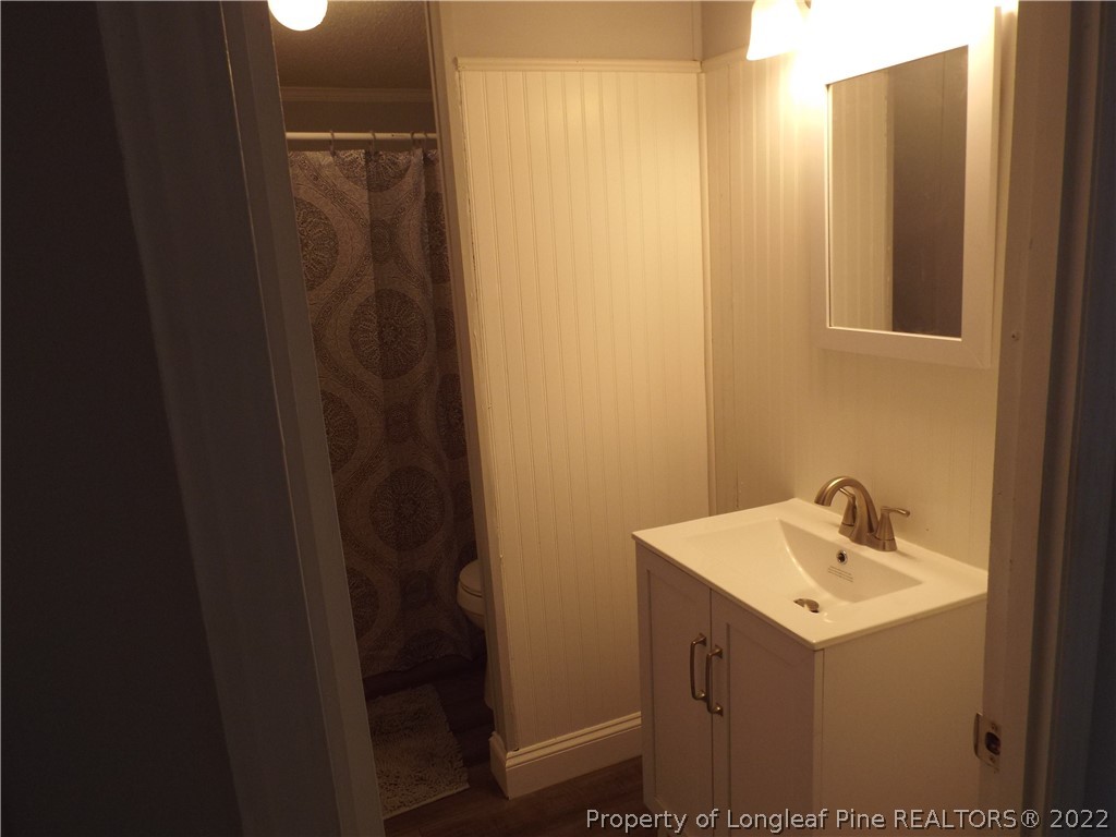73 Georgia Way Cameron, NC 28326 - Photo 18 of 28 a bathroom with a sink and mirror