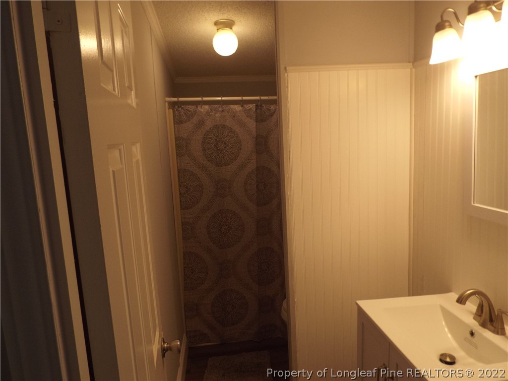 73 Georgia Way Cameron, NC 28326 - Photo 20 of 28 a bathroom with a sink and shower
