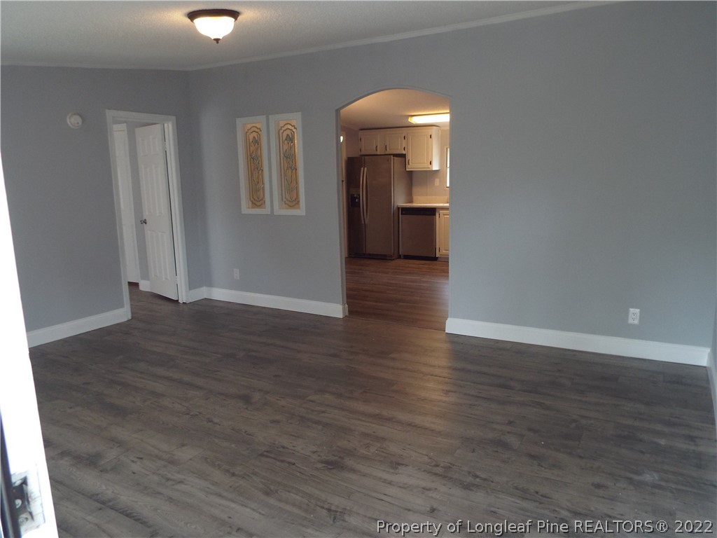 73 Georgia Way Cameron, NC 28326 - Photo 4 of 28 an empty room with wooden floor and mirror