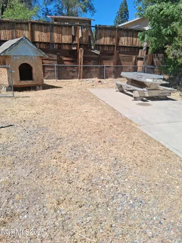 a view of house with yard and entryway