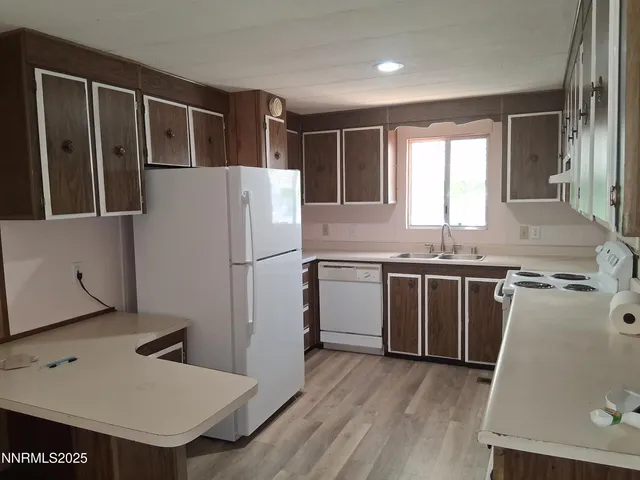 a kitchen with a sink a refrigerator and window
