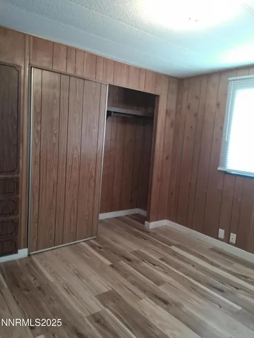 a view of wooden floor and closet in a room