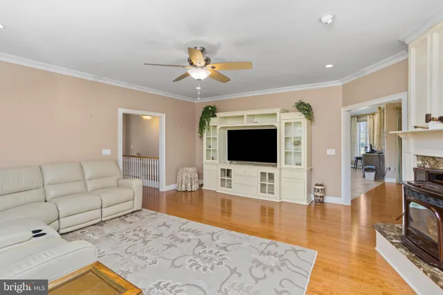 a living room with fireplace and a wooden floor