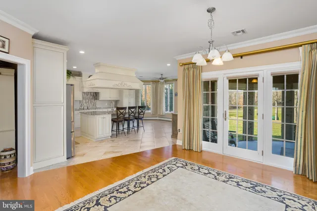 a kitchen with stainless steel appliances kitchen island granite countertop a table and chairs in it
