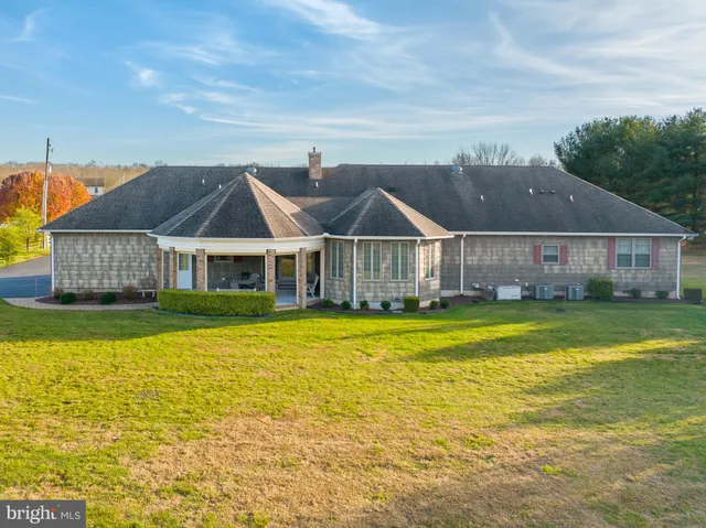 a dining room with furniture and a floor to ceiling window